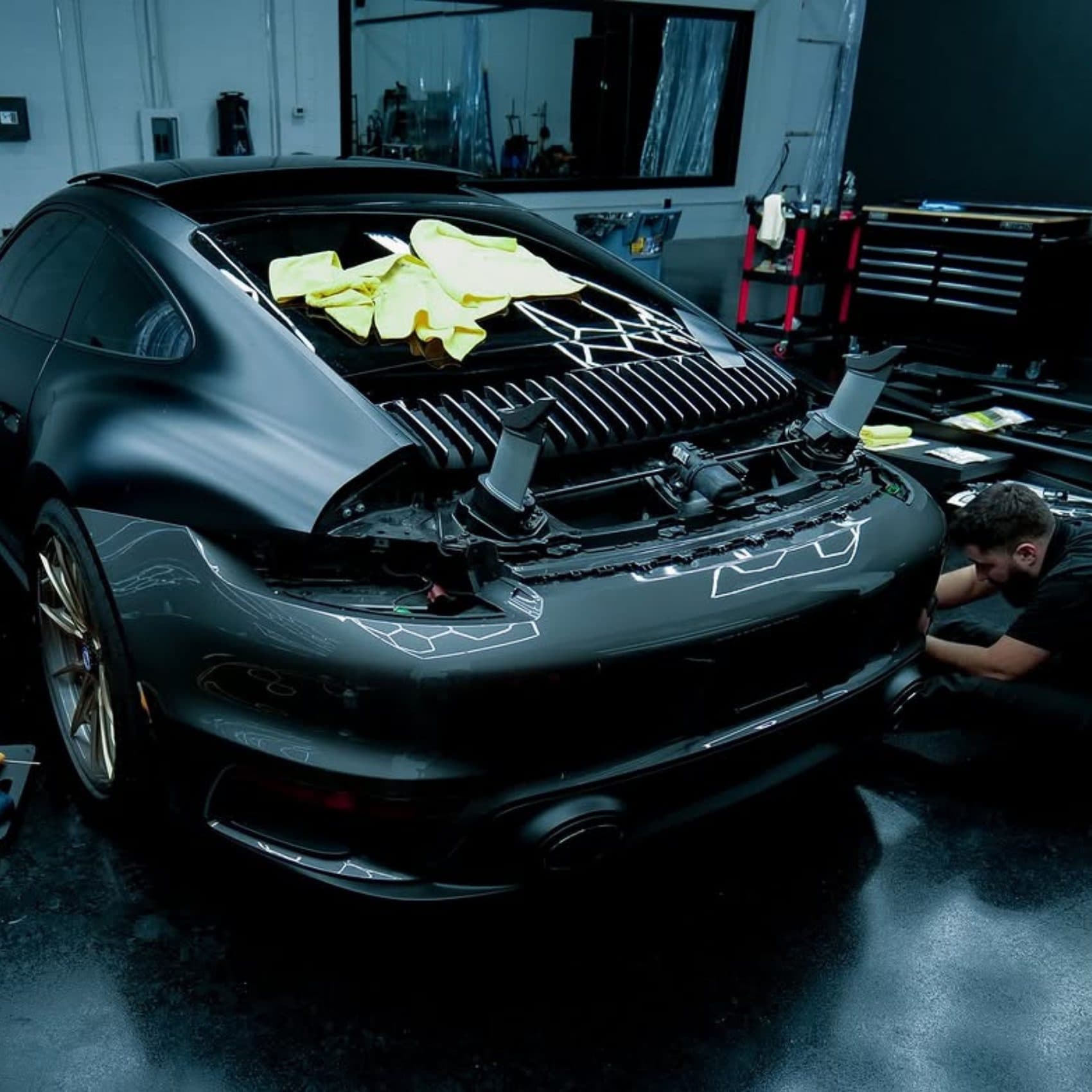 Sports car masked up and prepared before machine polishing